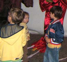 Kids in front of parade items, getting ready